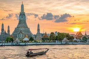 General image of Thialnd for the Travel With Insight Thiland category deptcting temples and river at sunset