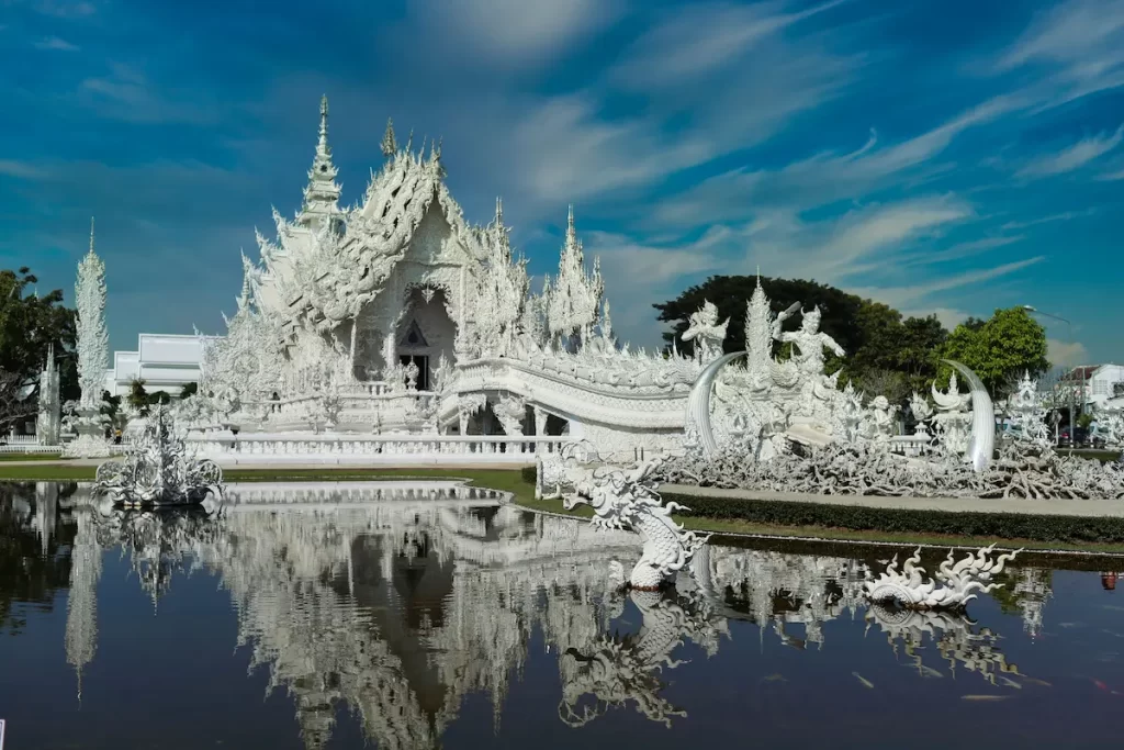 Wat Rong Khun (White Temple) in Chiang Rai, one of the best temples in Thailand, reflected in the surrounding pond