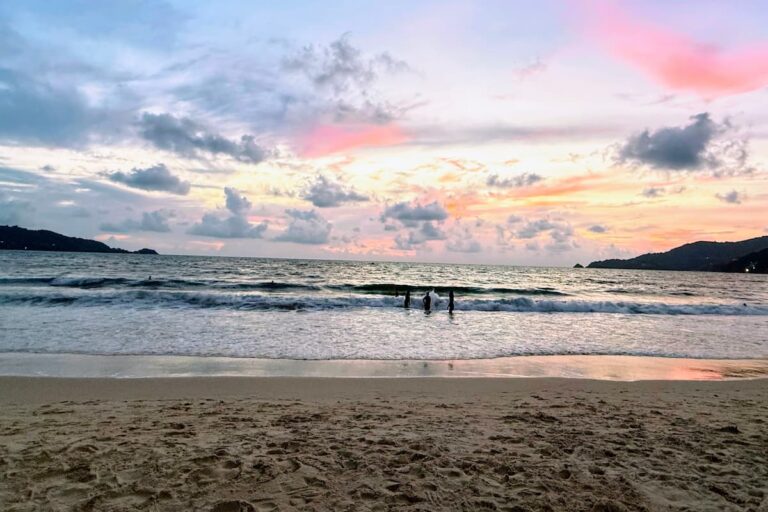 Visitors enjoying sunset at Patong Beach, one of the best free things to do in Patong.