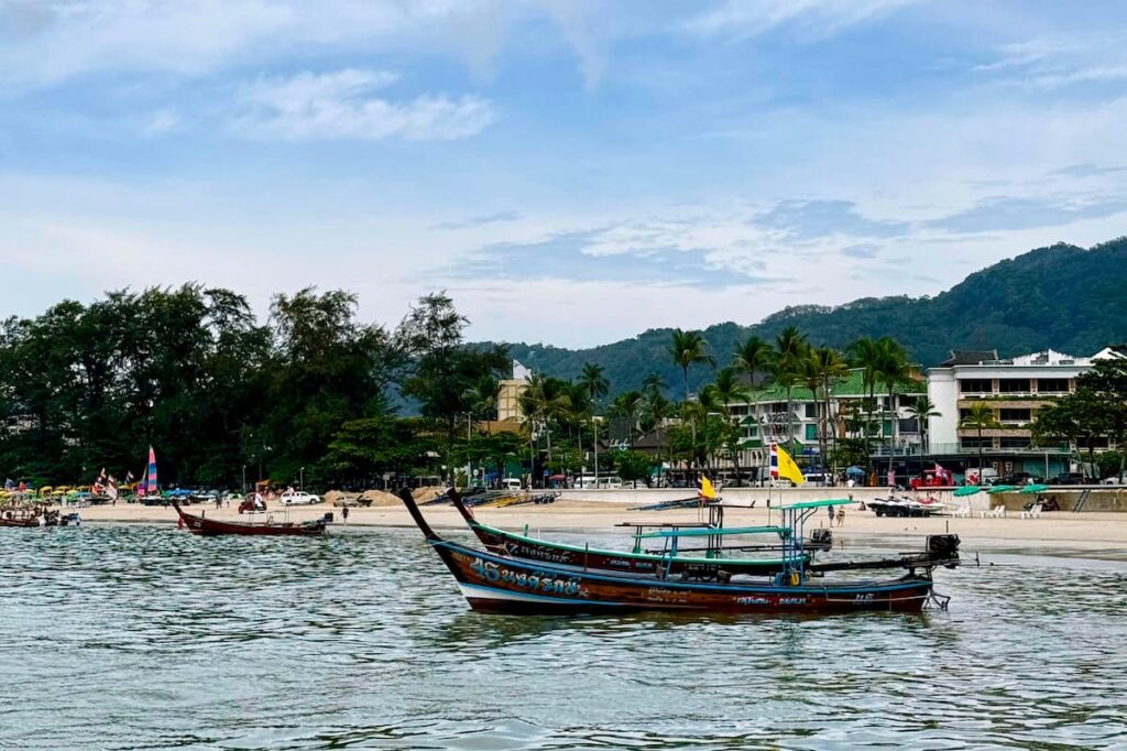 Longtail boats along Patong Beach, one of the best free things to do in Patong for travel photography.