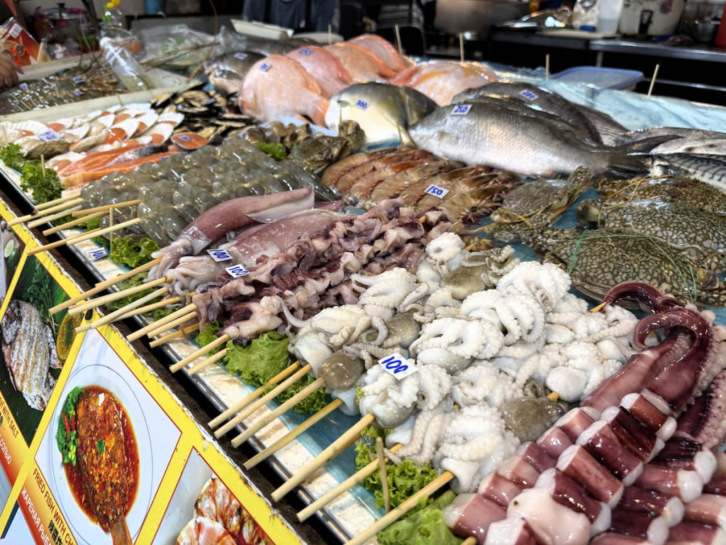 Fresh squid, prawns, fish and other seafood displayed at a Malin Plaza food stall.