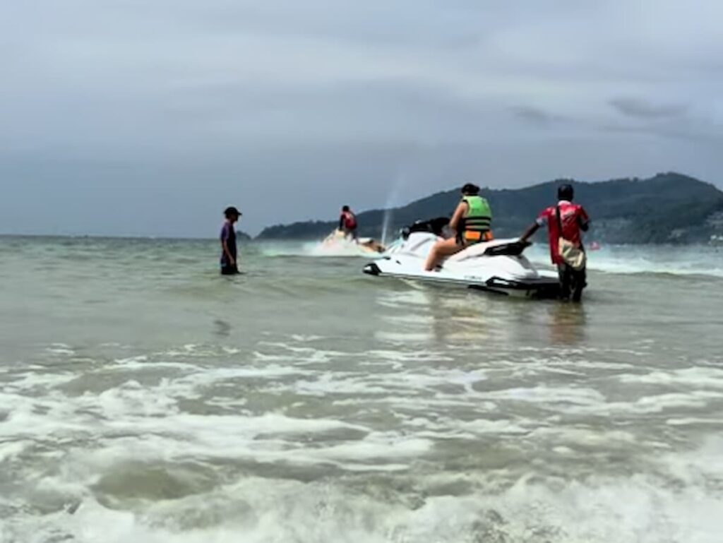 Visitors preparing to ride a jet ski during water sports in Patong at Patong Beach, Phuket.