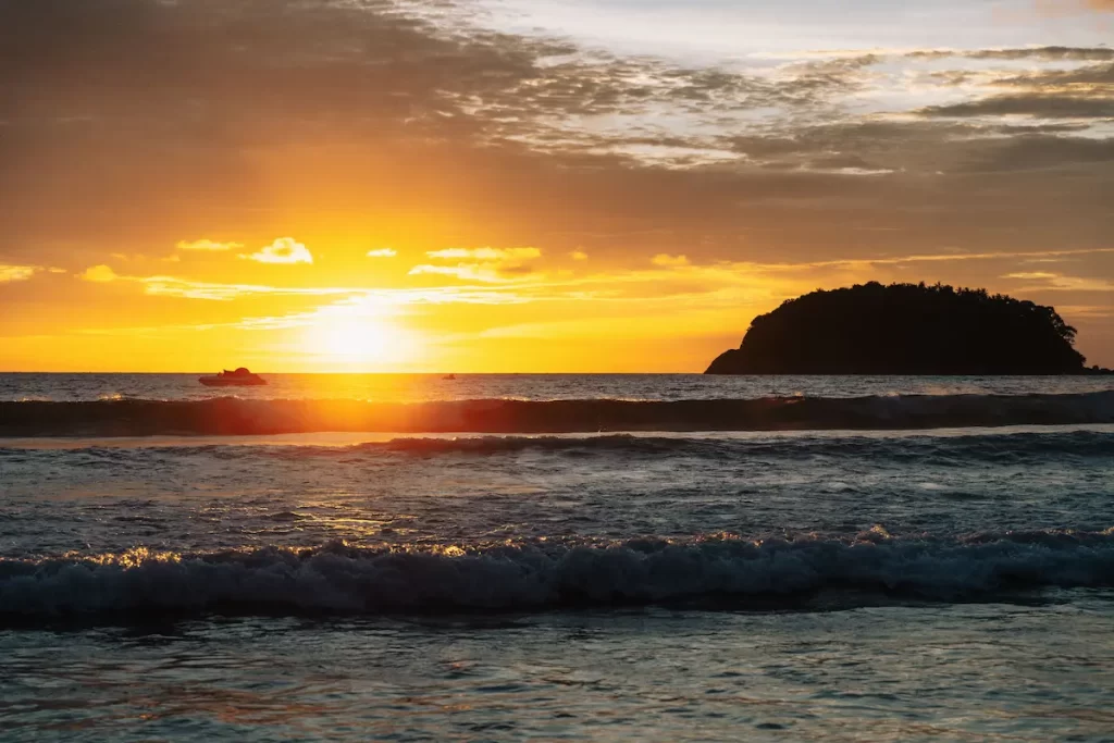 Why visit Phuket? A golden sunset over Kata Beach highlights one of Phuket's most beautiful beaches, known for its soft sand, clear water and spectacular evening views.
