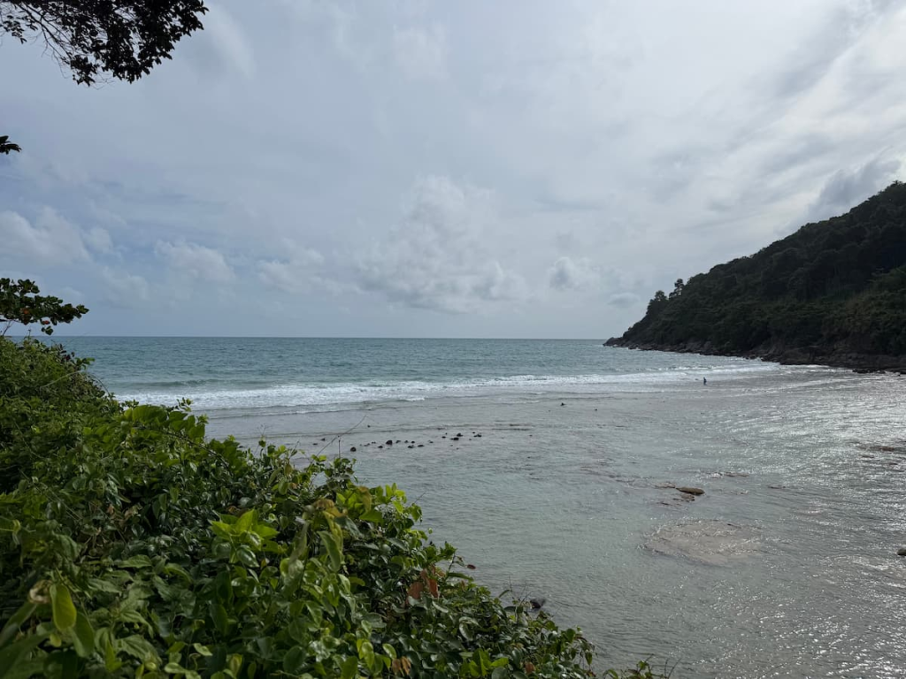 View across Merlin Beach in Phuket towards the forested headland and sheltered bay