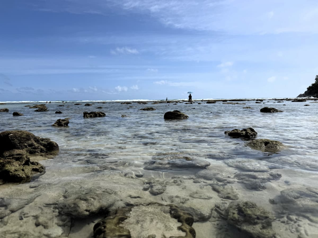 Shallow rocky water at Merlin Beach showing typical swimming and snorkelling conditions