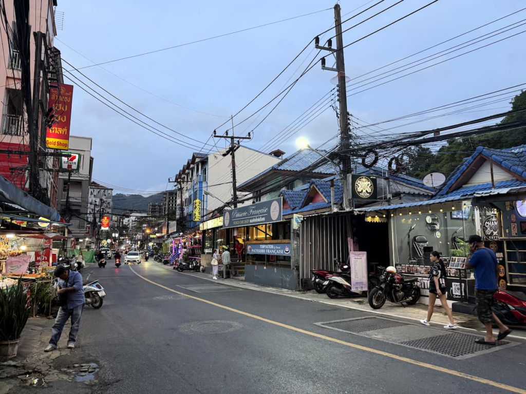 Nanai Road in Patong with guesthouses, restaurants, scooters and evening street activity