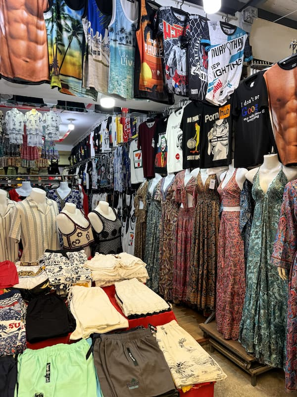 Clothing and souvenir stalls inside OTOP Patong shopping precinct.