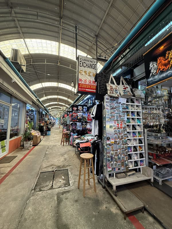 Covered shopping aisle with souvenir stalls at OTOP Patong.