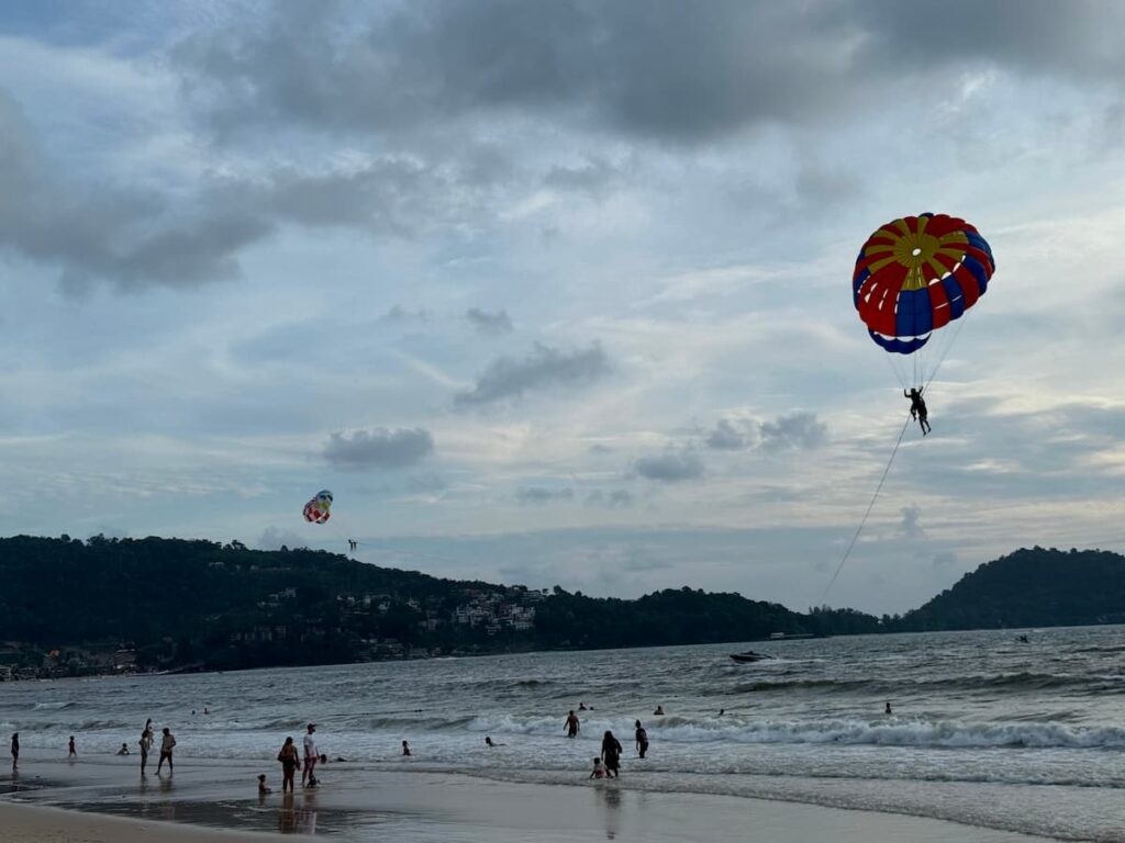 Parasailing over Patong Beach during a water sports adventure in Patong, Phuket.