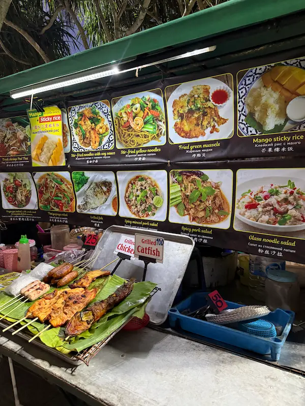 Beachfront food vendors serving a variety of meals along Patong Beach featured in our Patong Travel Guide.
