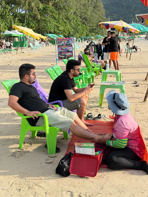A visitor enjoying a traditional Thai foot massage on Patong Beach featured in our Patong Travel Guide.