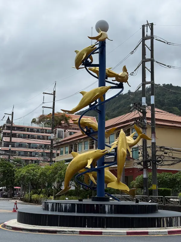 The dolphin sculpture at the northern Patong roundabout in Phuket, close to the Patong Phra Phrom Shrine.