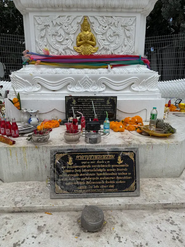 Offerings, incense burners and prayer plaques at the base of the Patong Phra Phrom Shrine in Phuket.