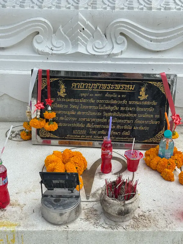 Prayer plaque, incense burners and offerings at the Patong Phra Phrom Shrine in Phuket, used by worshippers paying respects to Phra Phrom.