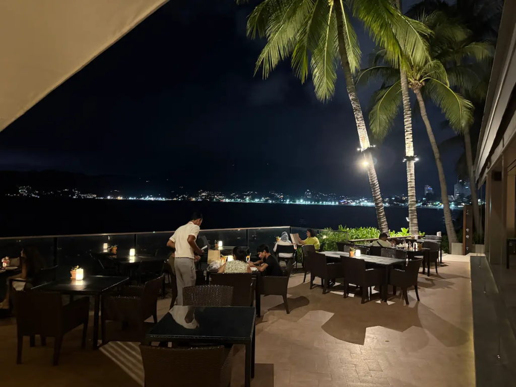 Waterfront restaurant dining overlooking Patong Bay at night