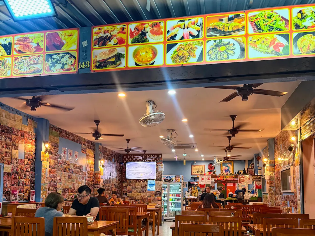 Interior of a casual Thai restaurant in Patong showing menu boards and dining area
