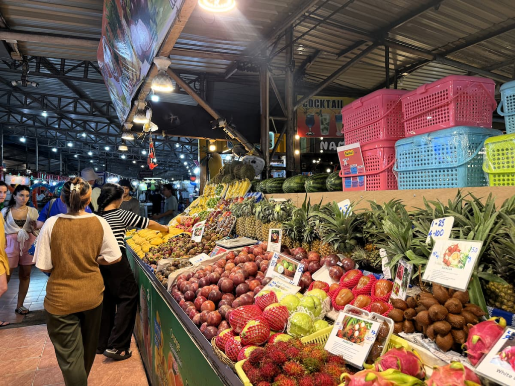 Tropical fruit including pineapple and dragon fruit displayed at Malin Plaza Patong.