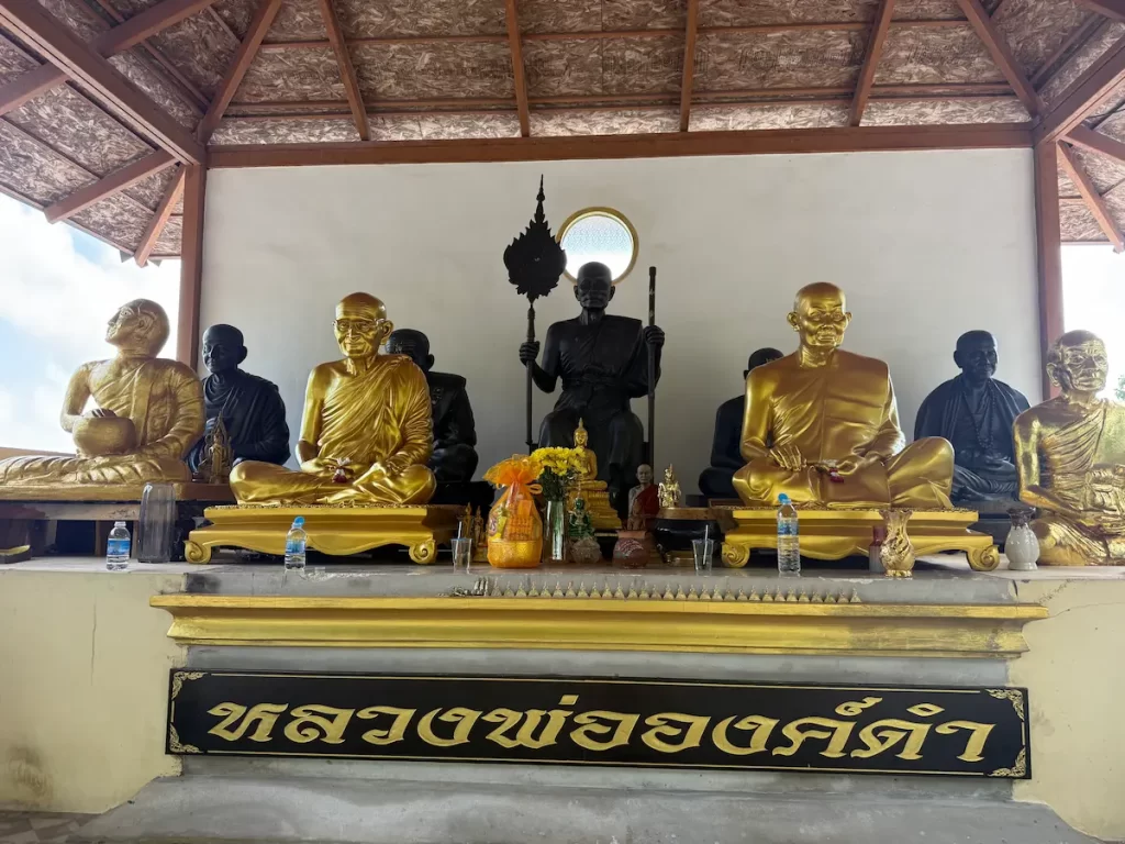 Luang Pho Ong Dam Shrine with statues of revered Buddhist monks at Wat Doi Thep Nimit in Phuket.