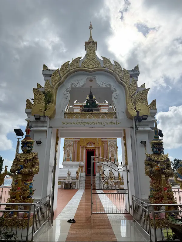Pair of Guardian Yaksha standing at the entrance gateway to the sacred chedi at Wat Doi Thep Nimit in Phuket.