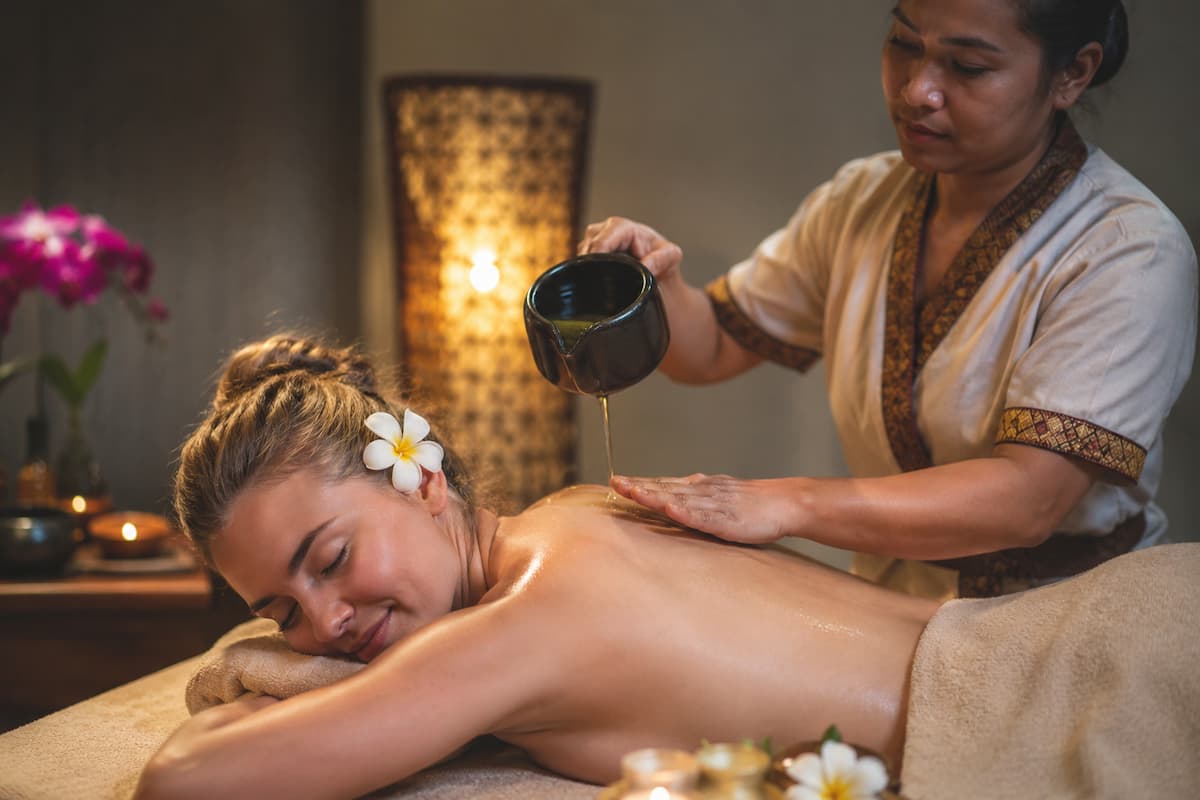 Luxury spa treatment illustrating the wellness and spas in Patong, with a therapist providing a relaxing aromatherapy massage.