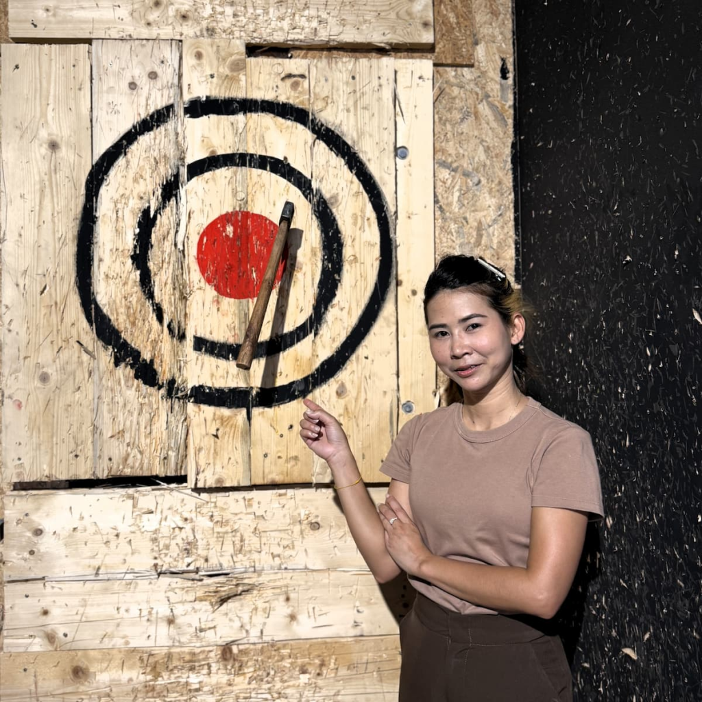 Visitor posing with an axe at AXCITING, an indoor target-sports experience featured among our recommended things to do in Patong.