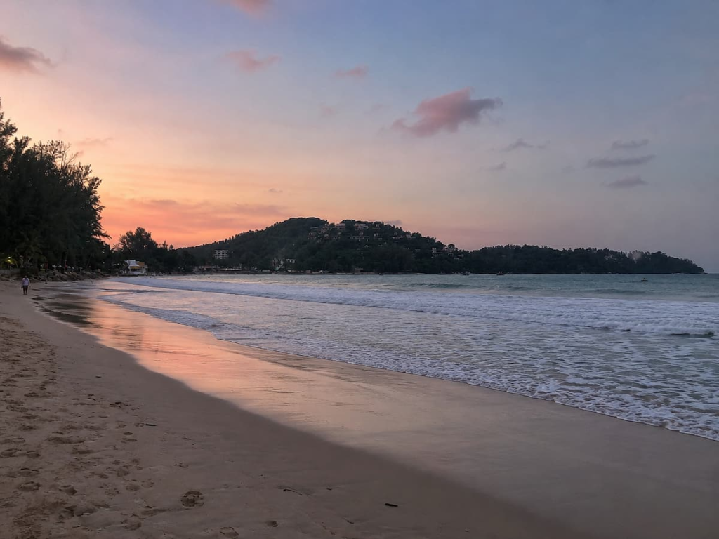 Evening colours reflecting across the waves and wet sand at Bang Tao Beach in Phuket.