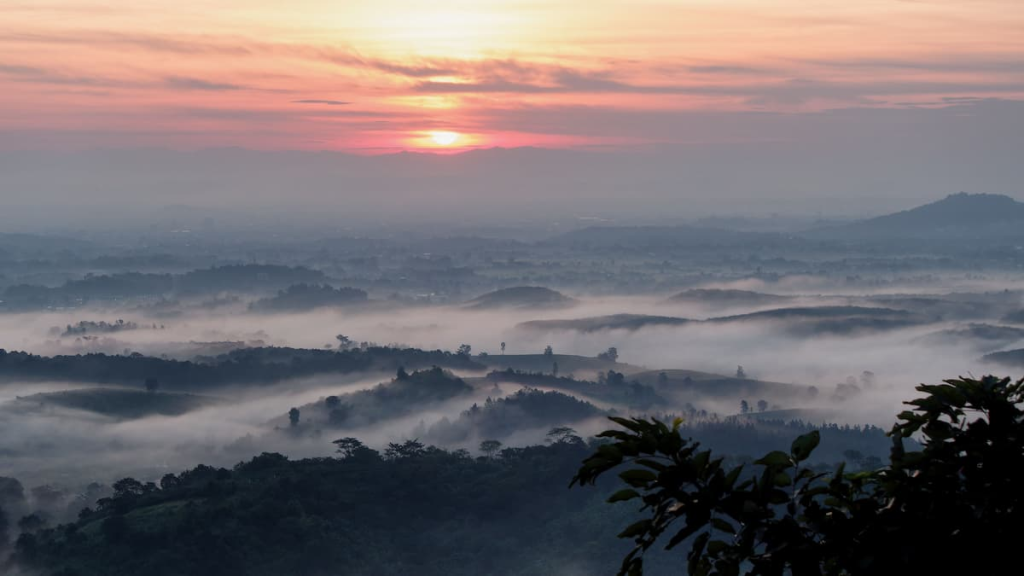 Thailand travel guide view of sunrise above mist-filled hills and mountain landscapes in Chiang Rai.