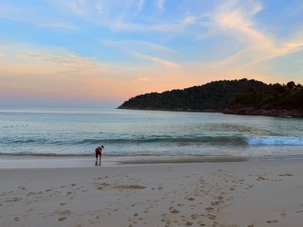 Patong Travel Guide evening view of Freedom Beach, capturing its peaceful atmosphere and sheltered bay at sunset.