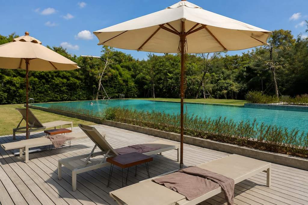 Swimming pool and shaded loungers at The Gallery Hotel Nai Harn, featured in our Phuket travel guide.