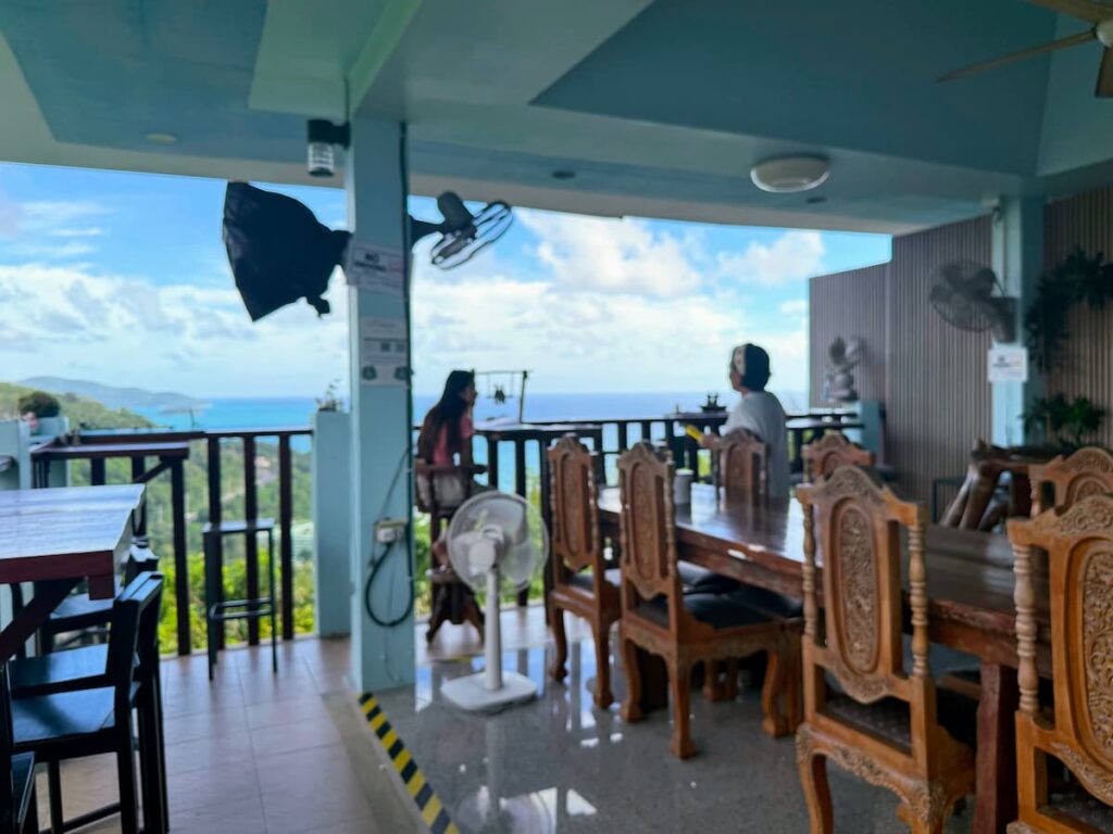 Open-air dining area at Grandma Homemade Thai Food near Patong with coastal views from the hillside