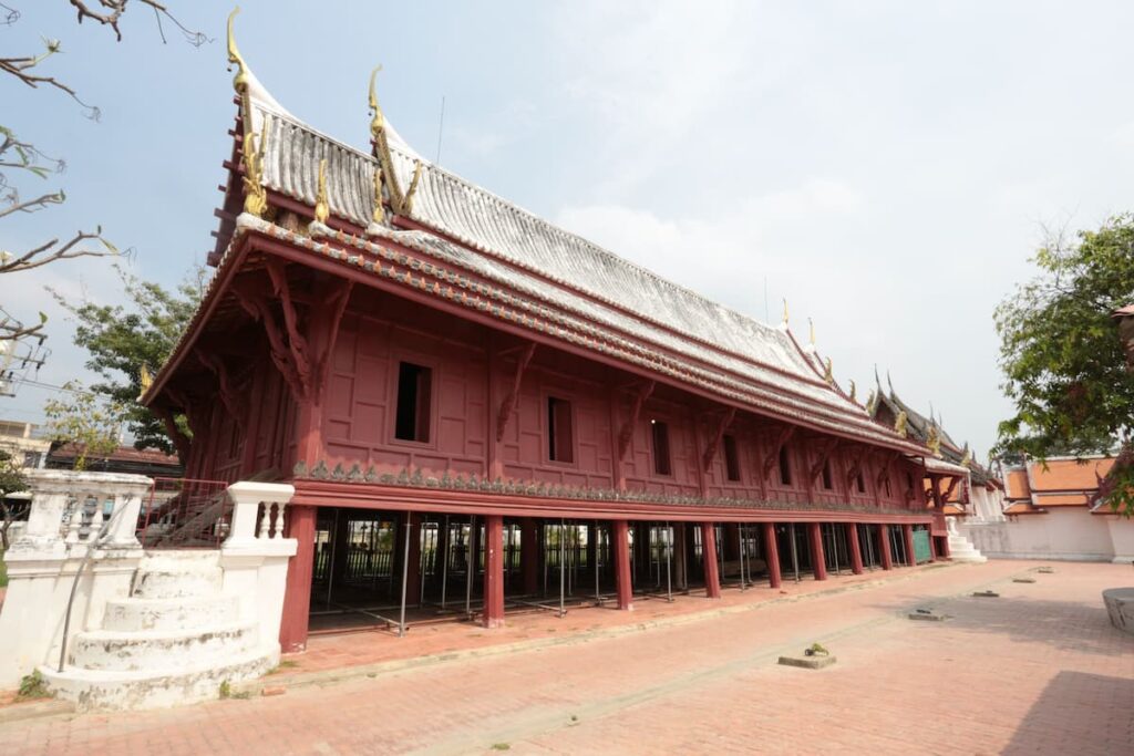 Elevated wooden sermon hall at Wat Yai Suwannaram, one of the historical places in Central Thailand.