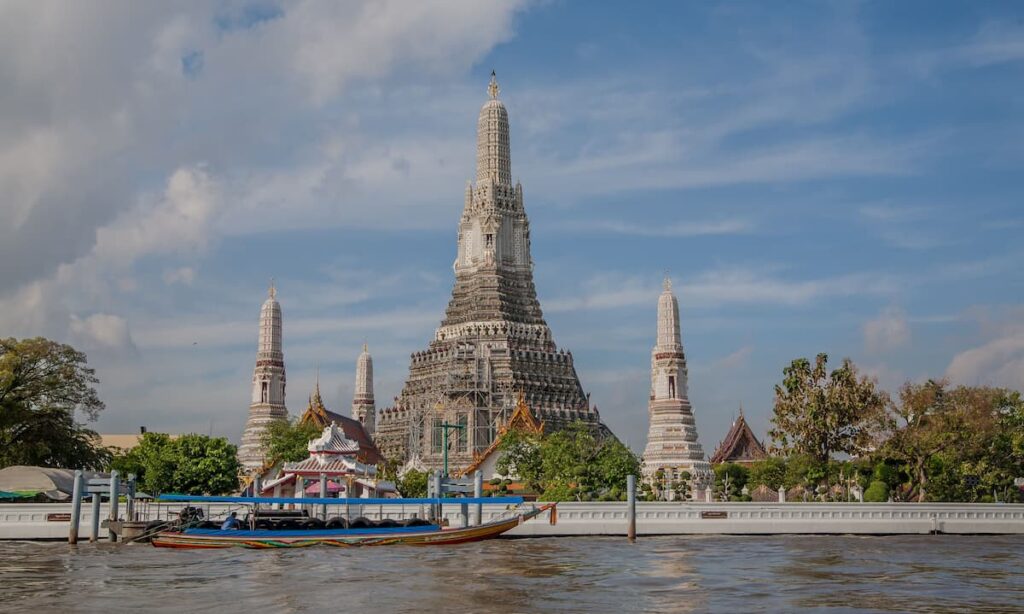 Wat Arun beside the Chao Phraya River introducing our collection of Thailand travel guides.