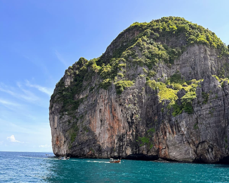 Island hopping in Southern Thailand beneath the limestone cliffs of the Phi Phi Islands.