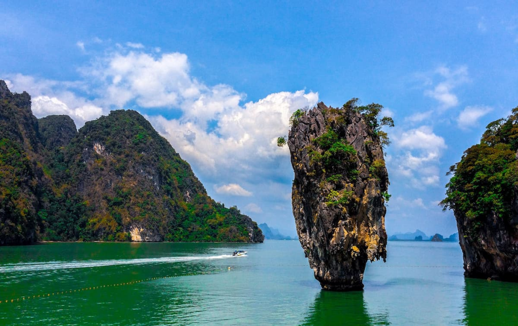 Thailand travel guide view of Khao Tapu rising from the emerald water at James Bond Island in Phang Nga Bay.