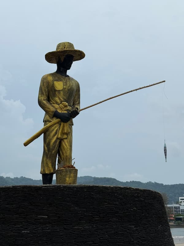 Fisherman statue near Karon Beach featured in our Karon Travel Guide to Phuket.