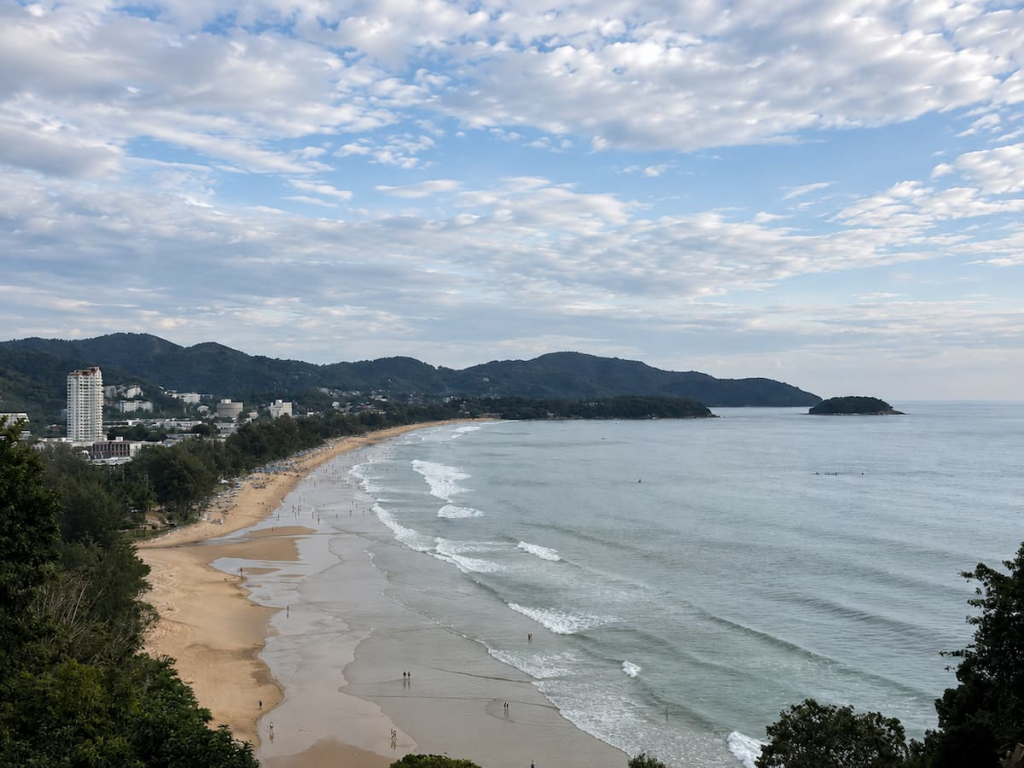 Karon Travel Guide view overlooking Karon Beach in Phuket, showing its sweeping golden-sand coastline and surrounding headlands.