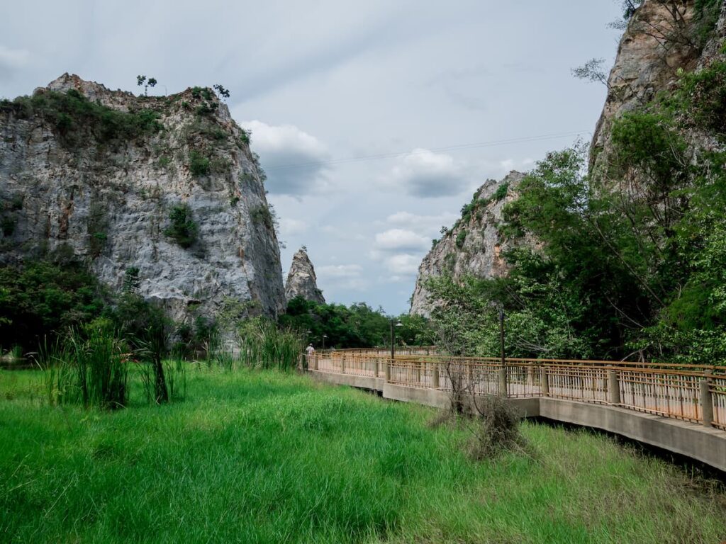 Limestone cliffs and walking path at Khao Ngu Stone Park in Ratchaburi, featured in where to go in Central Thailand.