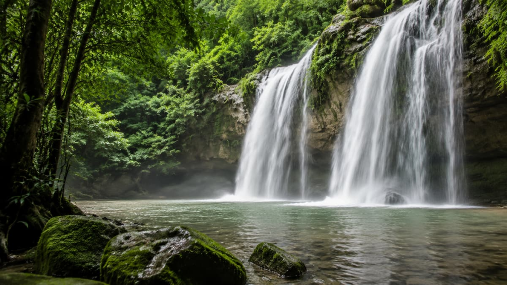 Thailand travel guide view of a forest waterfall flowing into a natural pool in Khao Yai National Park, Nakhon Ratchasima.