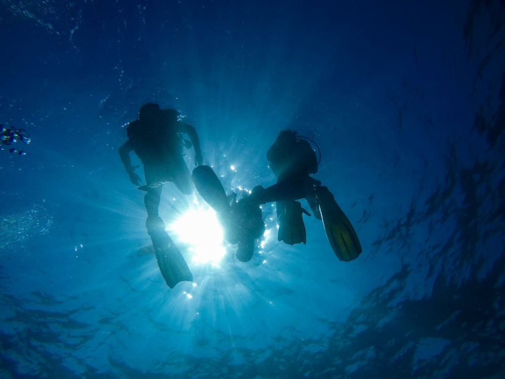 Scuba divers underwater illustrating learning to dive during an adventure holiday in Southern Thailand.
