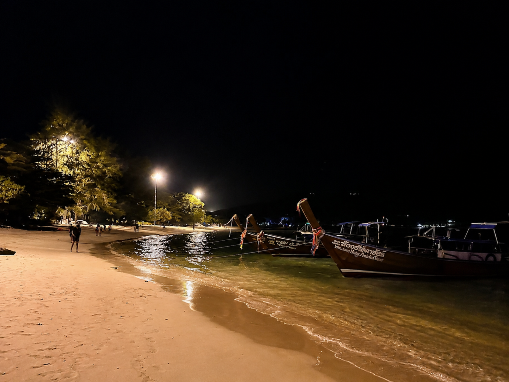 Longtail boats at Loh Dalum Beach during nightlife in Southern Thailand on Koh Phi Phi.