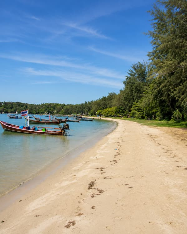 Longtail boats beside the coastline near Rawai in southern Phuket, featured in a Phuket travel guide