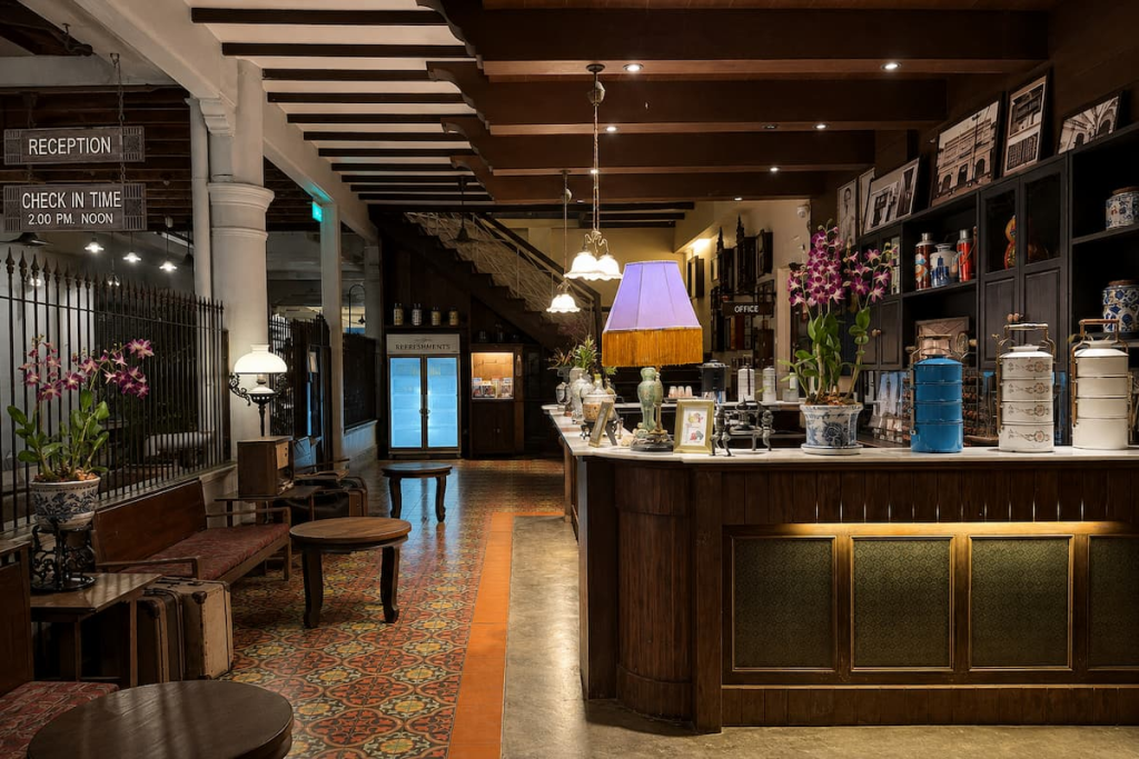 Heritage interior with patterned tiles and wooden furnishings at The Memory at On On Hotel, featured in our Phuket travel guide.