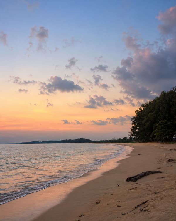 Sunset along the quiet shoreline of Nai Yang Beach, featured in a Phuket travel guide