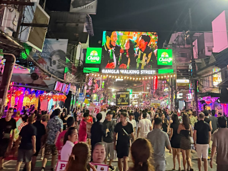 Nightlife in Southern Thailand crowds beneath neon signs on Bangla Road in Patong.