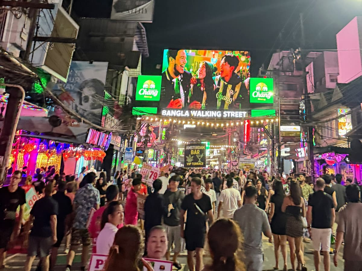 Nightlife in Southern Thailand crowds beneath neon signs on Bangla Road in Patong.