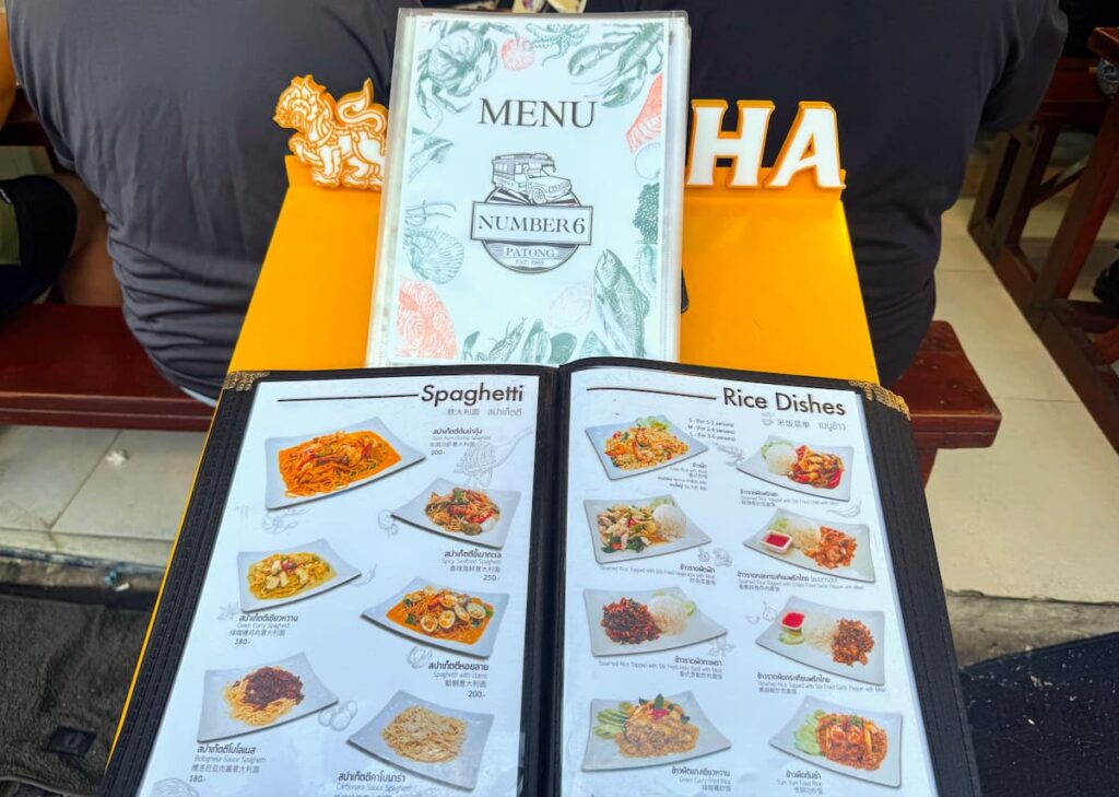 No. 6 Restaurant menu featured in the Patong Travel Guide, showing Thai rice dishes alongside familiar Western-style pasta choices.