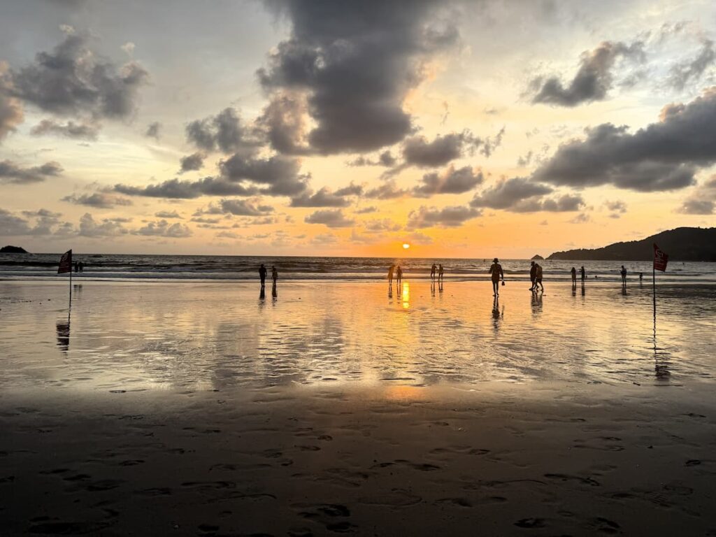 Visitors enjoying sunset at Patong Beach in Phuket, featured in our Patong Travel Guide as one of the best ways to end a day exploring the destination.