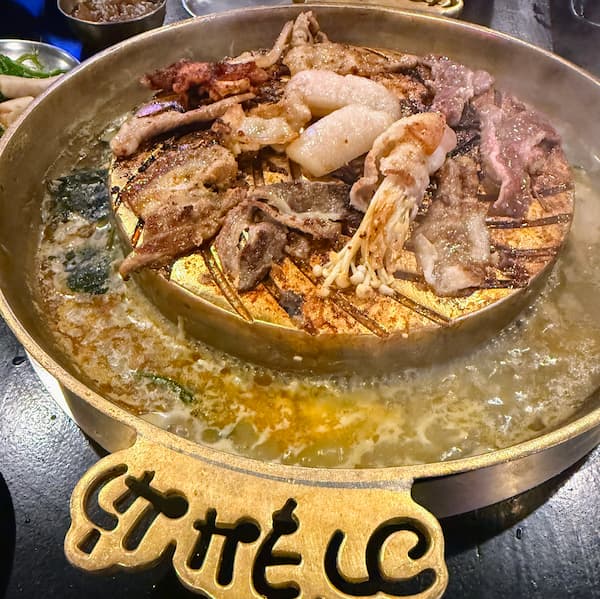 Traditional Thai Mookata BBQ and hotpot cooking at a local restaurant in Patong, Phuket, featured in our Patong Travel Guide.
