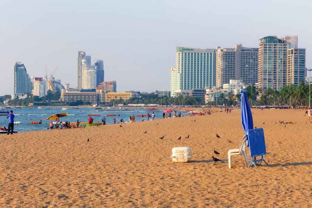 Pattaya Beach with visitors and high-rise hotels along the waterfront in Thailand