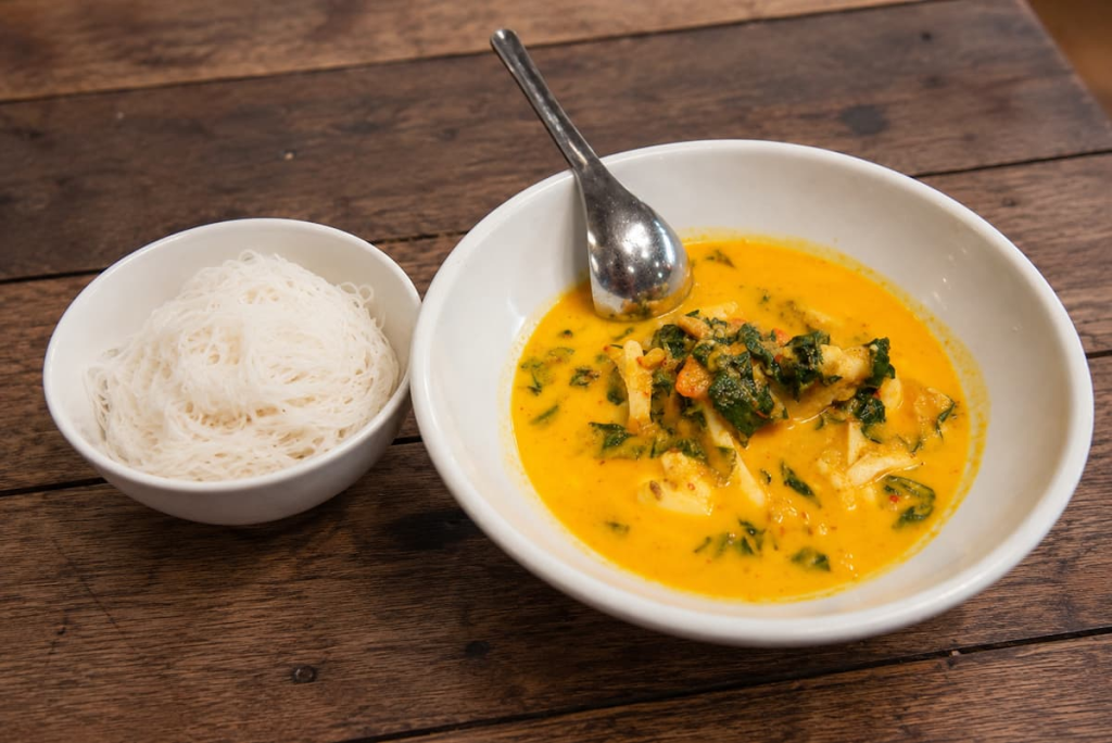Phuket-style crab curry with wild betel leaves served alongside fine rice vermicelli.